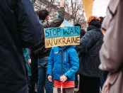 a kid protesting against the war in ukraine